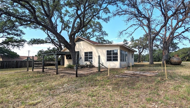 exterior space with a pergola and a lawn