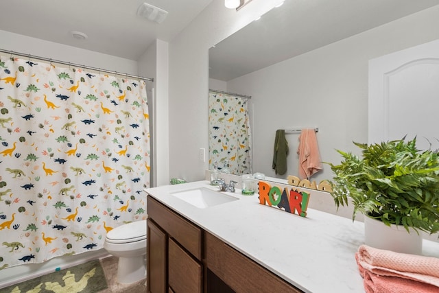 bathroom featuring vanity, a shower with shower curtain, and toilet