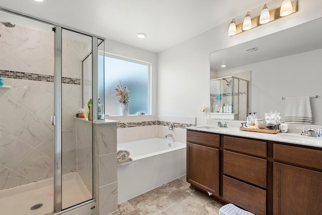 bathroom featuring shower with separate bathtub and vanity