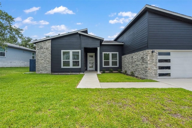 view of front facade with stone siding and a front yard