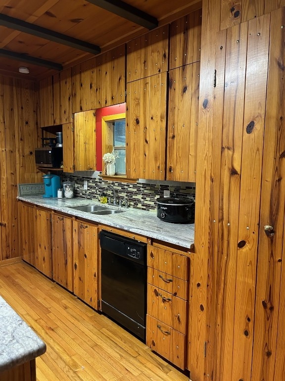 kitchen with wooden walls, light wood-type flooring, dishwasher, backsplash, and beamed ceiling