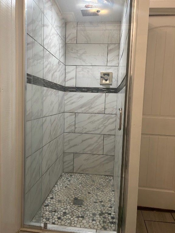 bathroom with a shower with door