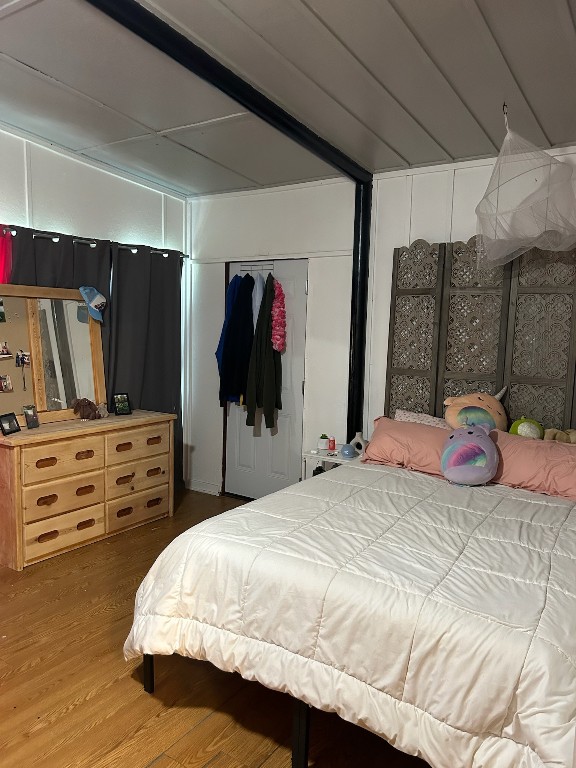 bedroom featuring hardwood / wood-style flooring and a closet