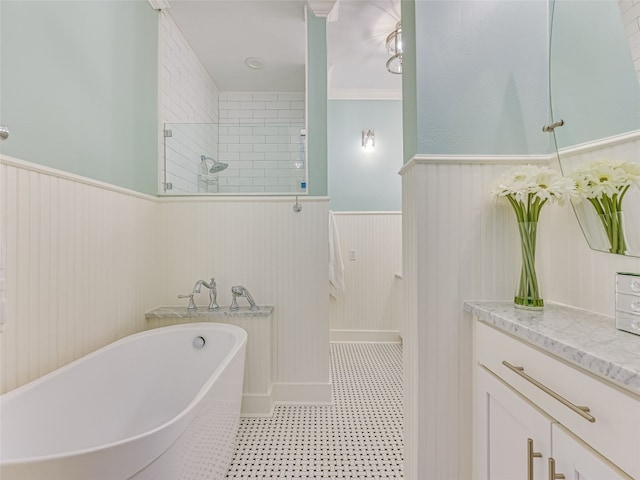 bathroom featuring tile flooring, crown molding, a bath to relax in, and vanity