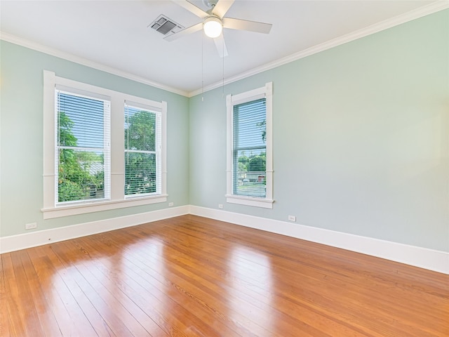 empty room featuring crown molding, ceiling fan, and hardwood / wood-style floors