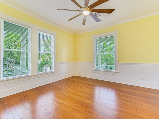 spare room featuring hardwood / wood-style floors, ornamental molding, and ceiling fan