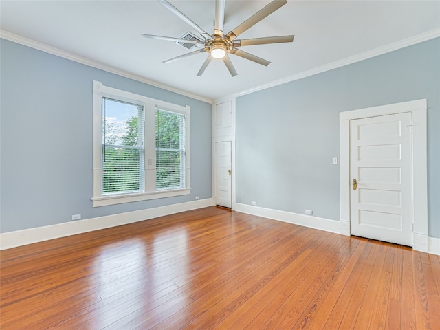 unfurnished room with a ceiling fan, light wood-style floors, baseboards, and ornamental molding