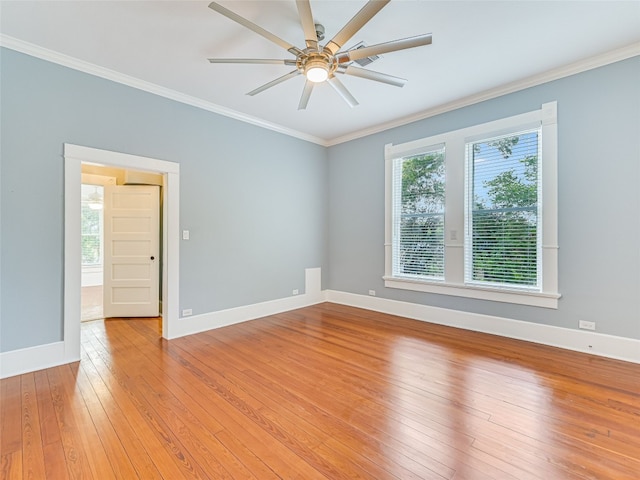 empty room with ceiling fan, crown molding, and wood-type flooring