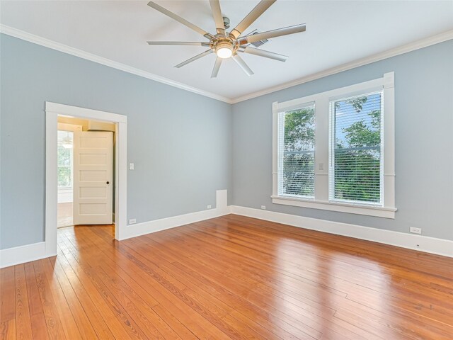 1302 Hill St, Bastrop, TX 78602 - unfurnished room featuring ornamental molding, light wood-style flooring, ceiling fan, and baseboards
