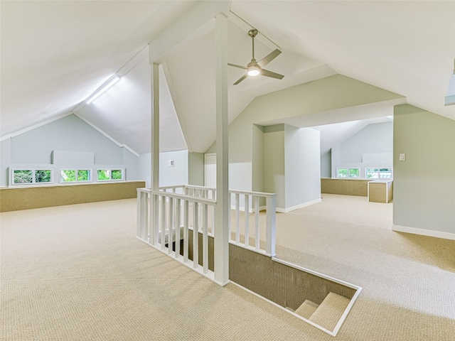 additional living space with ceiling fan, carpet floors, and lofted ceiling