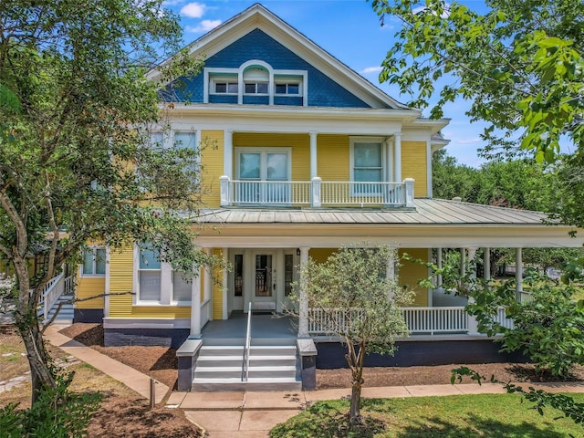view of front of property with a porch and a balcony