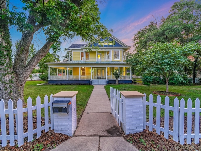 1302 Hill St, Bastrop, TX 78602 - victorian-style house featuring a porch, a gate, metal roof, and french doors