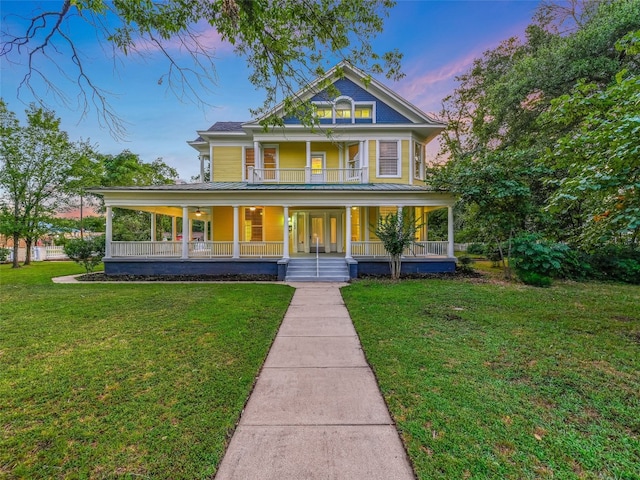 view of front of house with covered porch and a lawn