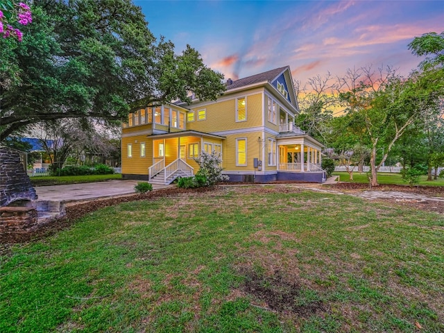 back house at dusk with a yard