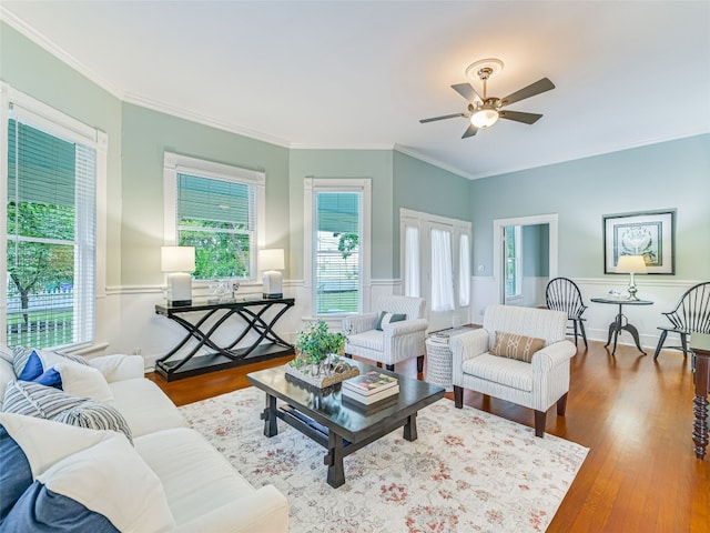 living room with crown molding, ceiling fan, and hardwood / wood-style floors