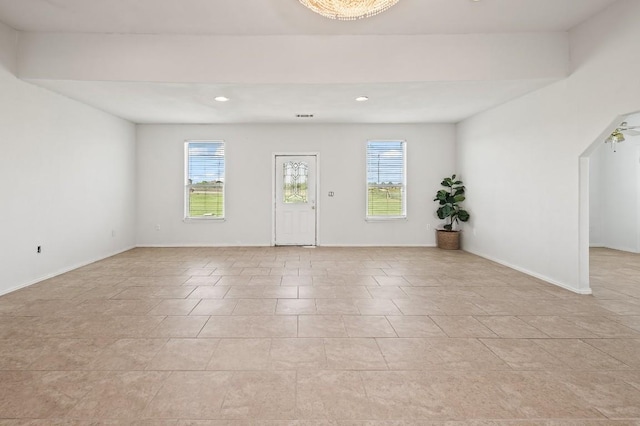 unfurnished room featuring ceiling fan and a healthy amount of sunlight