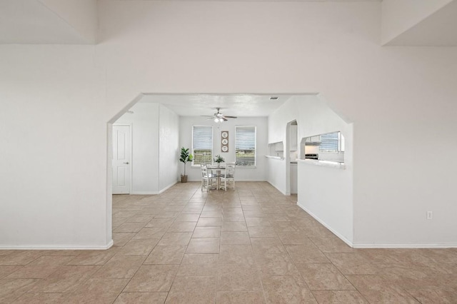 interior space with ceiling fan and light tile patterned floors