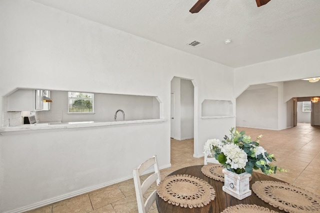 dining area featuring light tile patterned floors and ceiling fan