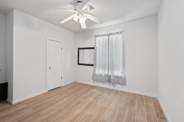 spare room featuring ceiling fan and light wood-type flooring