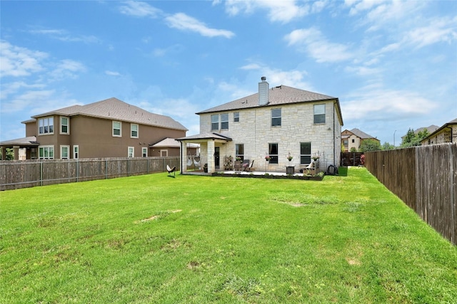 back of house featuring a yard