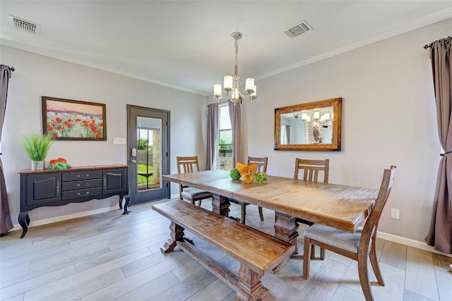 31451 Kingsway Rd, Georgetown, TX 78628 - dining area featuring a chandelier, light wood-style flooring, and ornamental molding