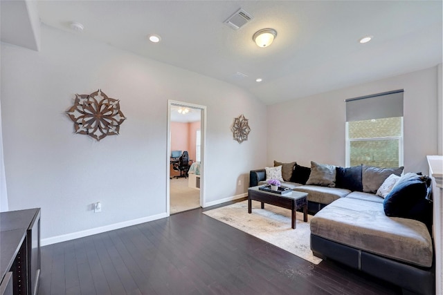 living room with plenty of natural light and dark hardwood / wood-style floors