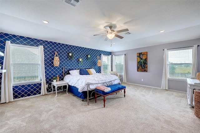31451 Kingsway Rd, Georgetown, TX 78628 - carpeted bedroom with multiple windows, an accent wall, a ceiling fan, and recessed lighting