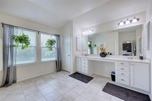 31451 Kingsway Rd, Georgetown, TX 78628 - ensuite bathroom featuring vanity, tile patterned flooring, and vaulted ceiling