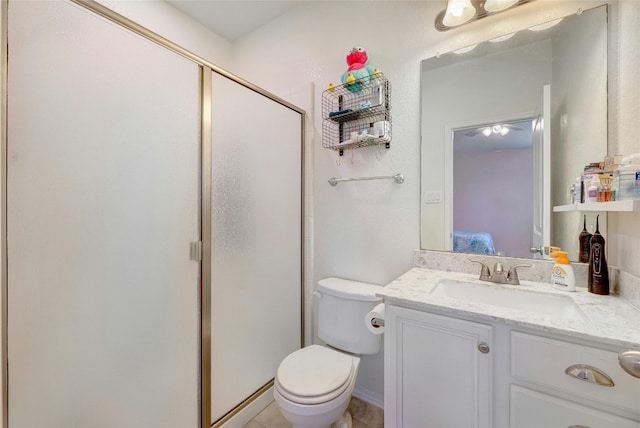 bathroom featuring toilet, vanity, and walk in shower