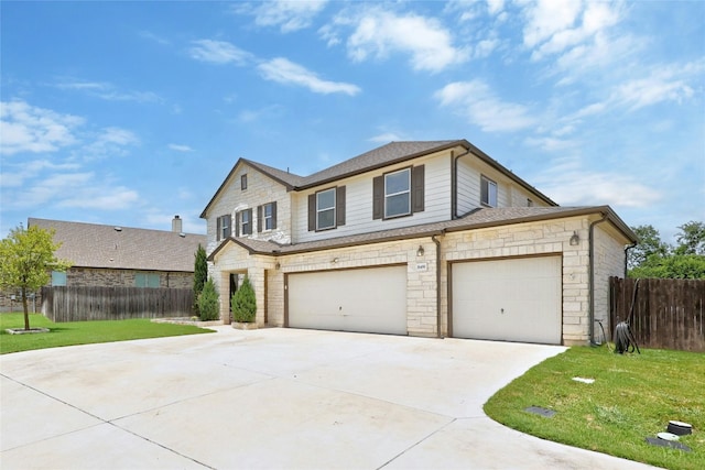 view of front of property with a garage and a front lawn