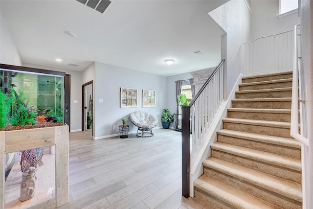 31451 Kingsway Rd, Georgetown, TX 78628 - stairs featuring wood finished floors and recessed lighting