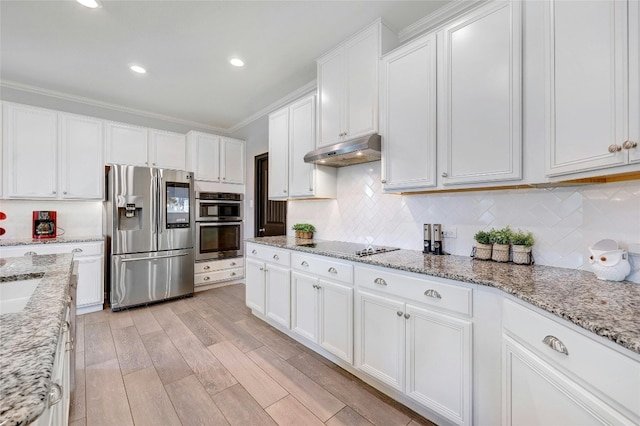 kitchen featuring white cabinetry, light stone counters, light hardwood / wood-style flooring, backsplash, and appliances with stainless steel finishes