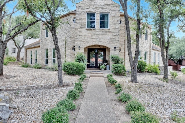 view of front of home featuring stone siding and french doors