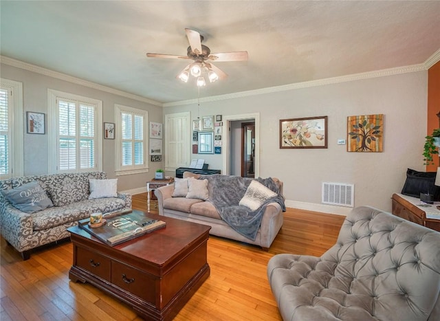 living room with light wood-type flooring, ceiling fan, and ornamental molding