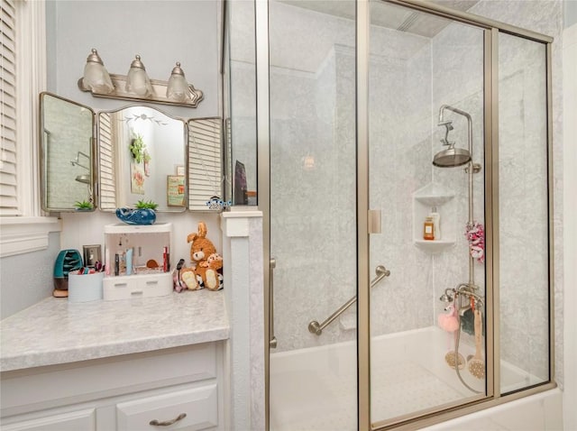 bathroom with shower / bath combination with glass door and vanity