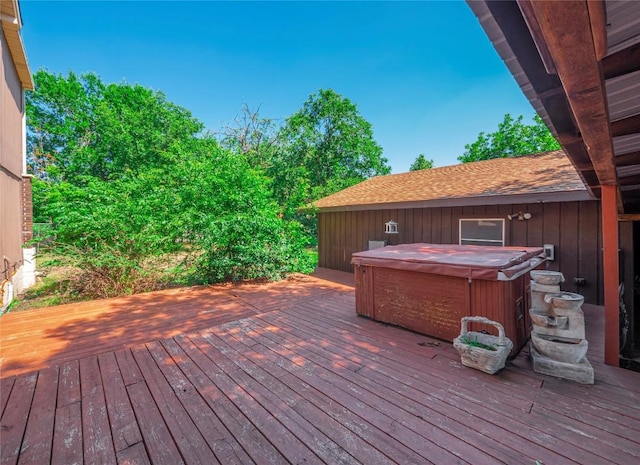 wooden deck with a hot tub