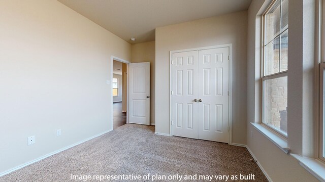 unfurnished bedroom with a closet and carpet floors