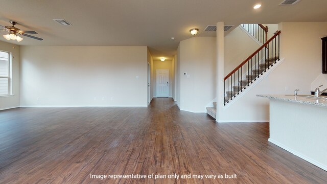 unfurnished living room featuring ceiling fan, dark hardwood / wood-style flooring, and sink