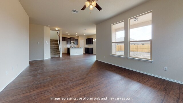 unfurnished living room featuring dark hardwood / wood-style floors and ceiling fan