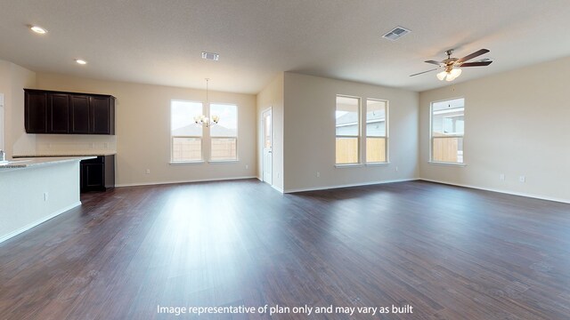 unfurnished living room featuring ceiling fan with notable chandelier and dark hardwood / wood-style flooring