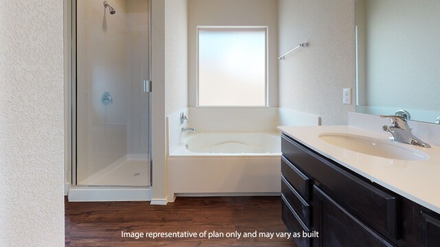 bathroom with vanity, hardwood / wood-style flooring, and plus walk in shower