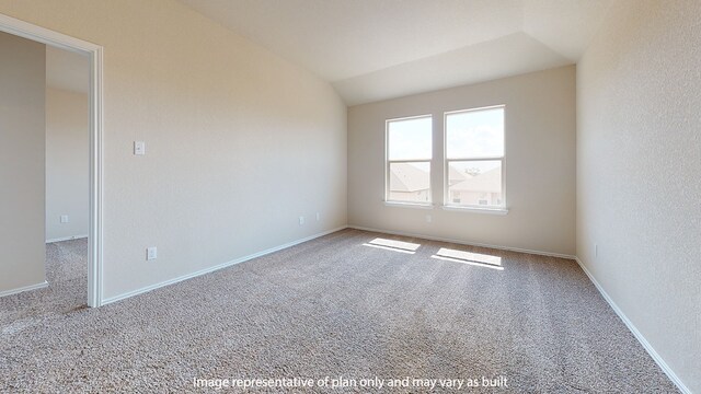 spare room with carpet floors and lofted ceiling