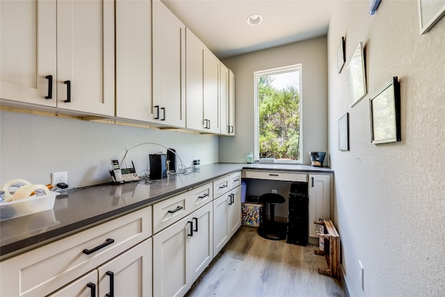 kitchen with light hardwood / wood-style flooring and white cabinets