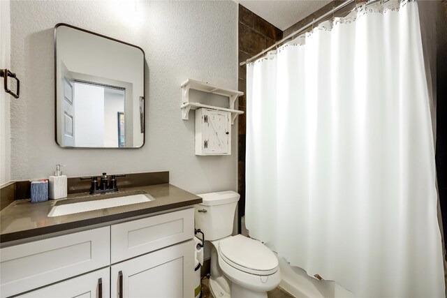 bathroom featuring vanity, toilet, and a shower with shower curtain