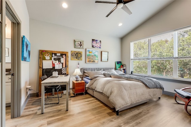 bedroom featuring ceiling fan, light hardwood / wood-style floors, and vaulted ceiling