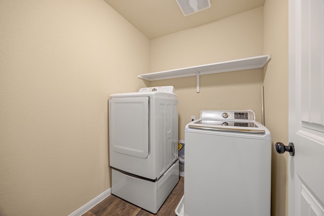 washroom featuring washing machine and dryer and dark hardwood / wood-style flooring