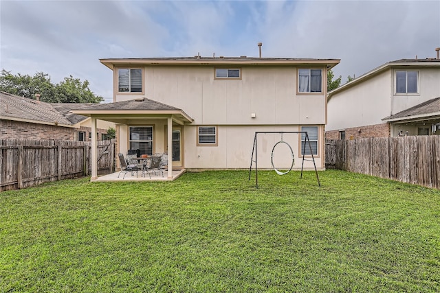 back of house with a yard and a patio