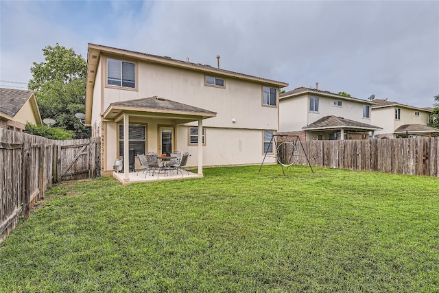 rear view of property with a patio area and a yard