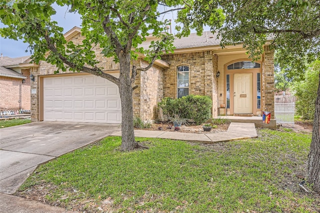 ranch-style home with a front lawn and a garage