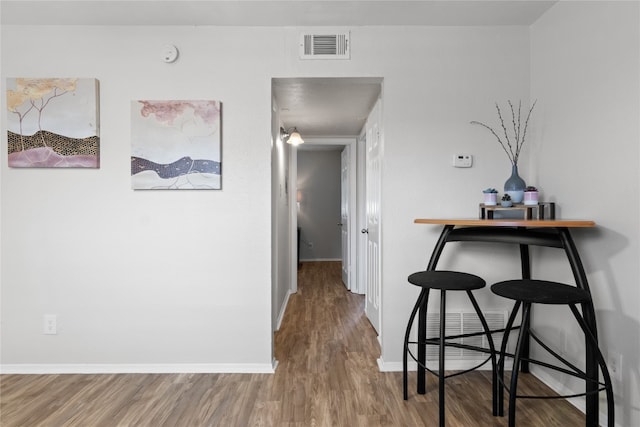 corridor with wood-type flooring